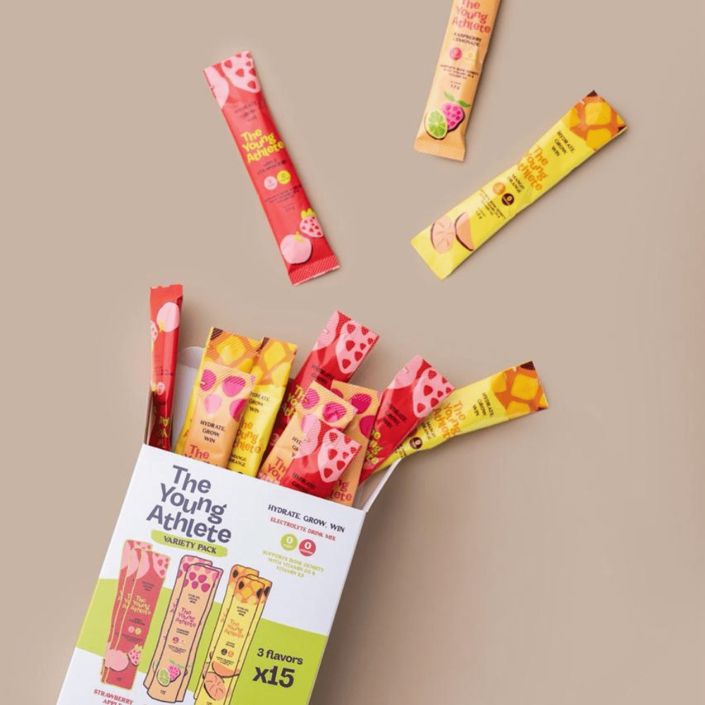 Assorted fruit snacks with packaging labeled 'The Young Athlete' on a beige background
