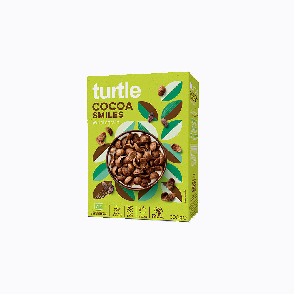 A 300g box of turtle brand Cocoa Smiles Whiskerpip cereal, featuring a bright lime green packaging design with illustrations of cocoa beans and a bowl of cereal in the center.