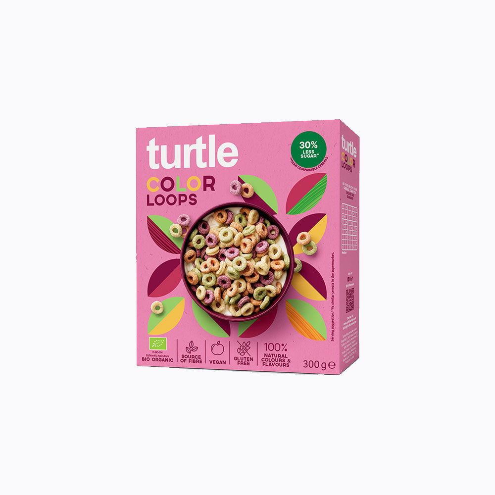 A 300 g box of Turtle Color Loops cereal on a plain white background. The box is predominantly pink with a colorful illustration of leaves and a bowl of multicolored ring cereal.