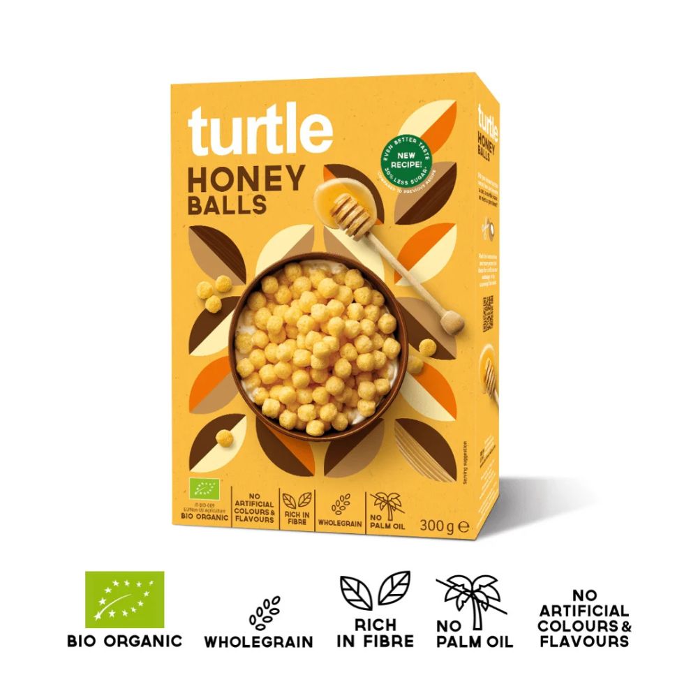 A box of turtle Honey Balls cereal on a white background, featuring a yellow-orange design with a bowl of honey balls, a wooden spoon, and product feature icons at the bottom.