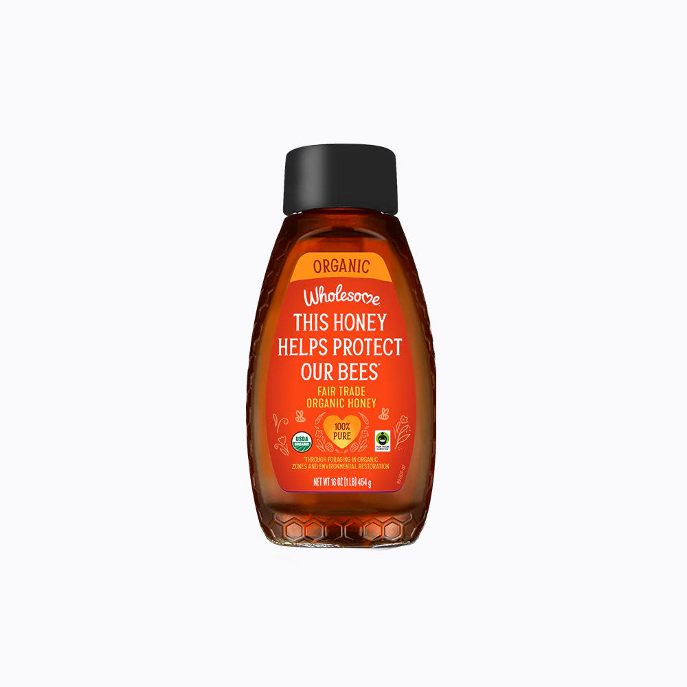 Bottle of Wholesome Sweeteners honey with label on a white background