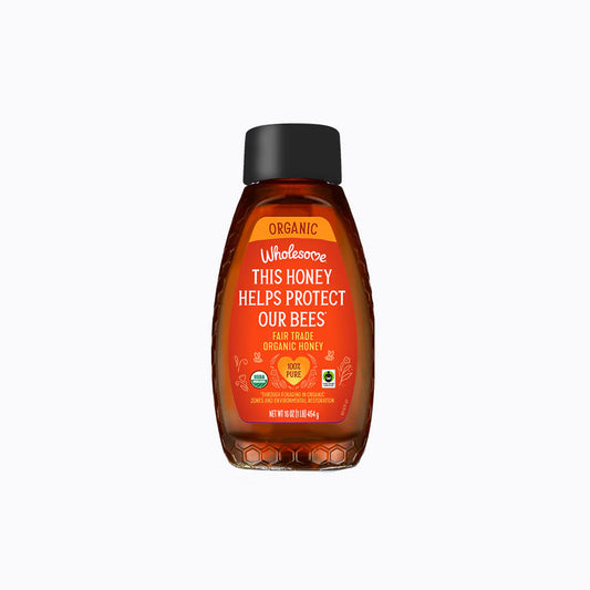 Bottle of Wholesome Sweeteners honey with label on a white background