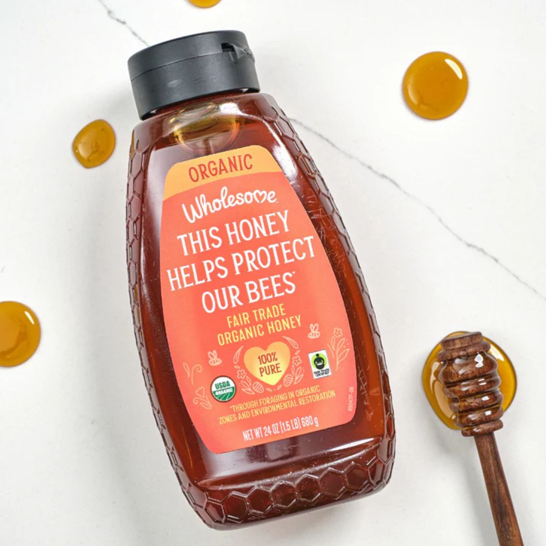 Bottle of Wholesome Honey with a label on a white background