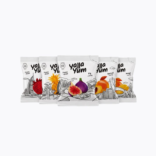 Five Yalla Yum flavor snack pouches arranged in a fan shape on a plain white background. The white packaging features black line art and colorful illustrations of different fruits, including strawberry, fig, apricot, and mango.