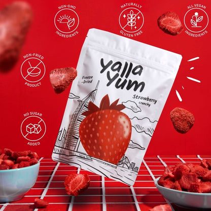 yalla yum strawberry crunchy snack package on a red background with strawberry illustrations