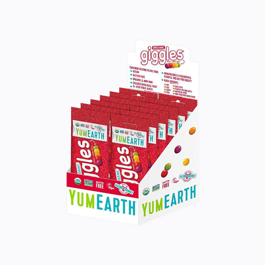 A YumEarth Giggles candy display box filled with individual red candy bags, shown on a plain white background.