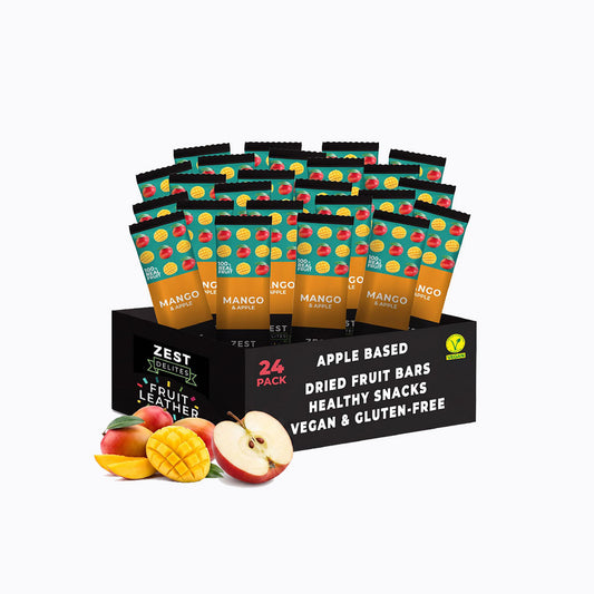 A 24-pack display box of Zest Zestix Mango Apple Based Dried Fruit Bars, featuring multiple individually wrapped bars fanned out from a black cardboard tray with fruit illustrations and a few fresh mangoes and an apple on a white background.