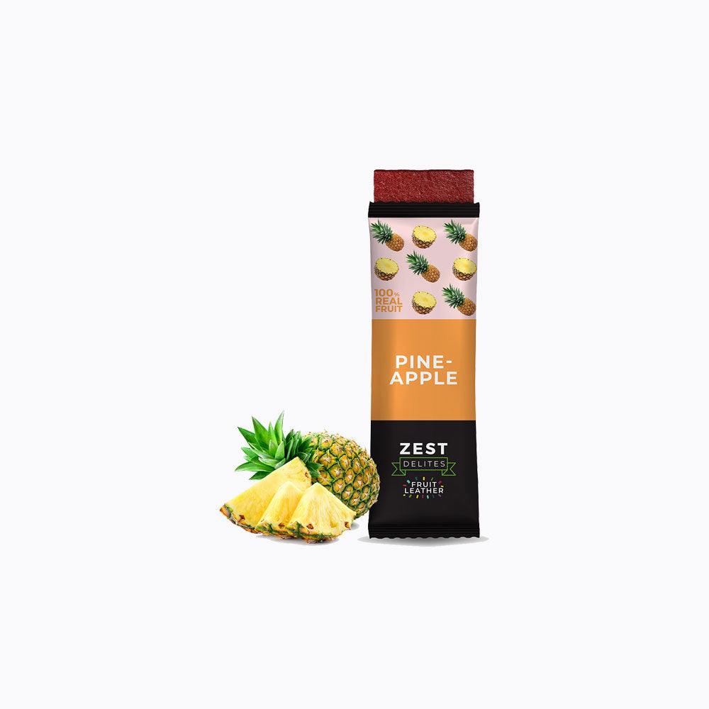 A 24-pack display box of Zest Zestix Mango Apple Based Dried Fruit Bars, featuring multiple individually wrapped bars fanned out from a black cardboard tray with fruit illustrations and a few fresh mangoes and an apple on a white background.
