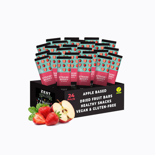 A 24-pack display box of Zest Zestix Mango Apple Based Dried Fruit Bars, featuring multiple individually wrapped bars fanned out from a black cardboard tray with fruit illustrations and a few fresh mangoes and an apple on a white background.