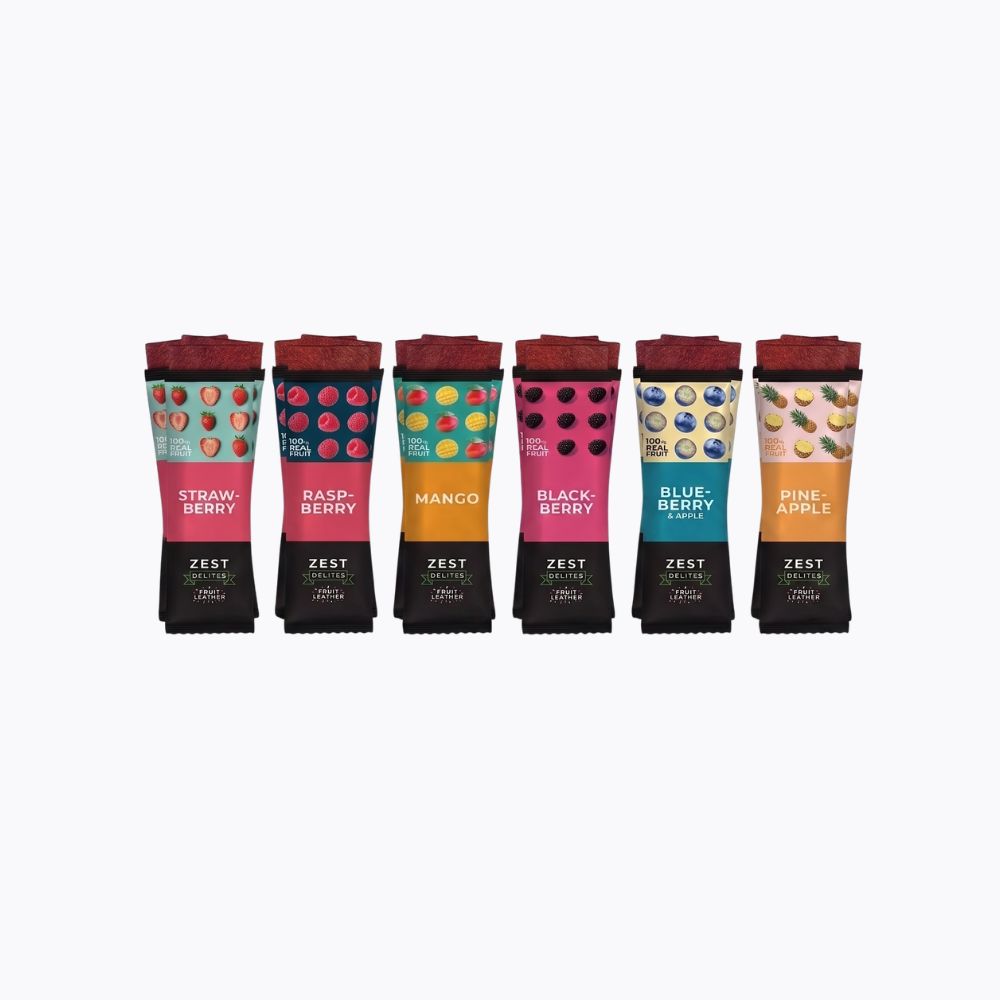 Six ZEST fruit jam tubes arranged in a row on a plain white background. The tubes are labeled Strawberry, Raspberry, Mango, Blackberry, Blueberry, and Pineapple, each with its own colorful label and dark red cap.
