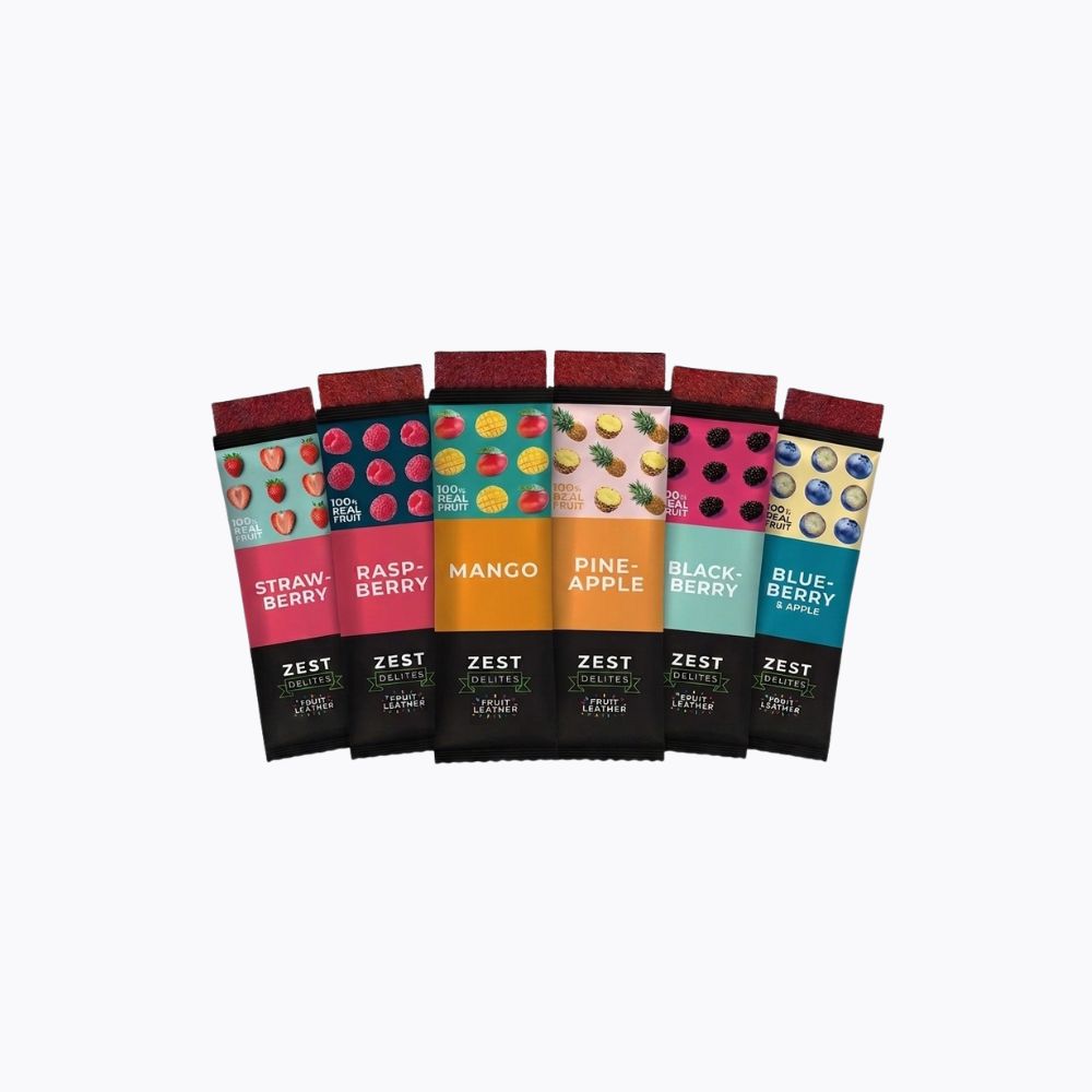 Six Zest Energy bars in individual packaging, arranged in a fan shape against a plain white background. The flavors shown are Strawberry, Raspberry, Mango, Pineapple, Blackberry, and Blueberry, each with its own vibrant color-coded wrapper and dark chocolate bar visible.