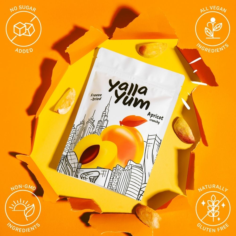 Yalla Yum apricot snack package on an orange background with branding icons.